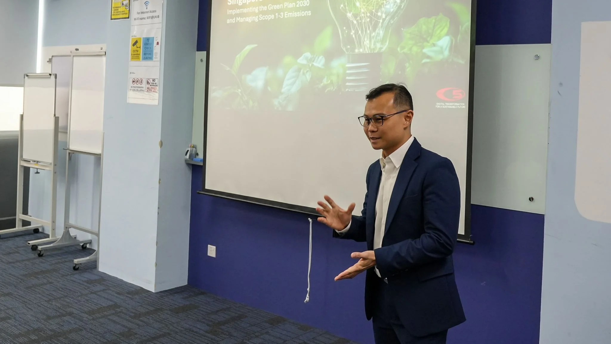 Terence Kok presenting on Singapore's Green Plan 2030 and Scope 1-3 emissions at ST Logistics Sustainability Masterclass, Devan Nair Institute